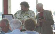 Cdr. William Weidner displays the plaque awarded to Alexander K. Murphy.