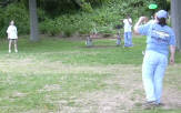 Commander Alison tosses a disc with Sea Scouts